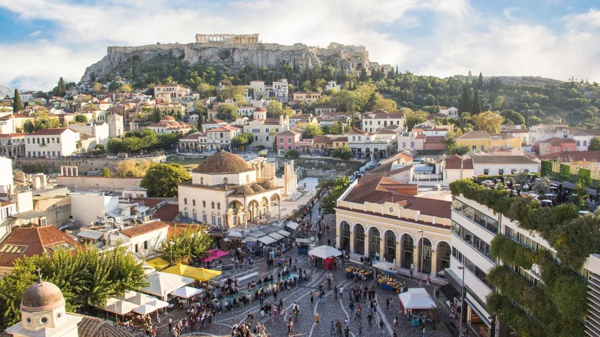 An aerial view of central Athens with the Acropolis visible in the background